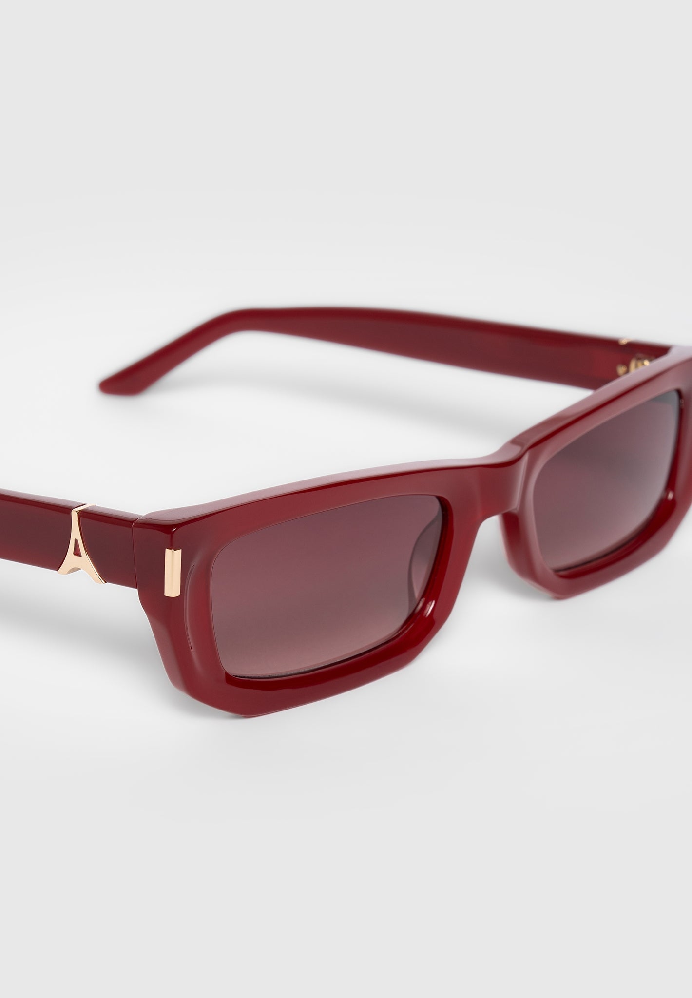 Red Curved-Frame Sunglasses with UV Protection | Manière De Voir