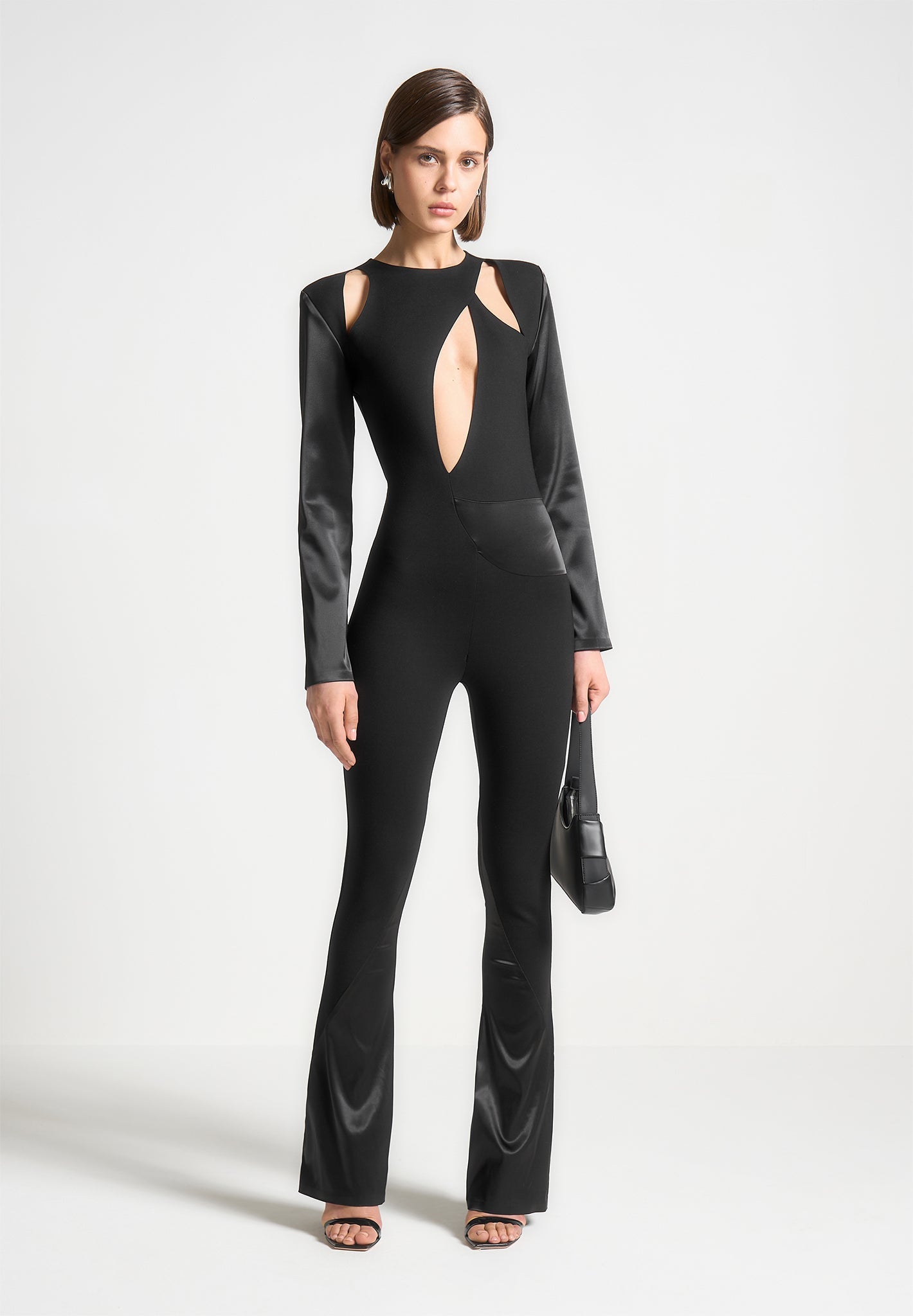 Black Satin & Bandage Flared Jumpsuit with Cut Out Detail | Manière De Voir