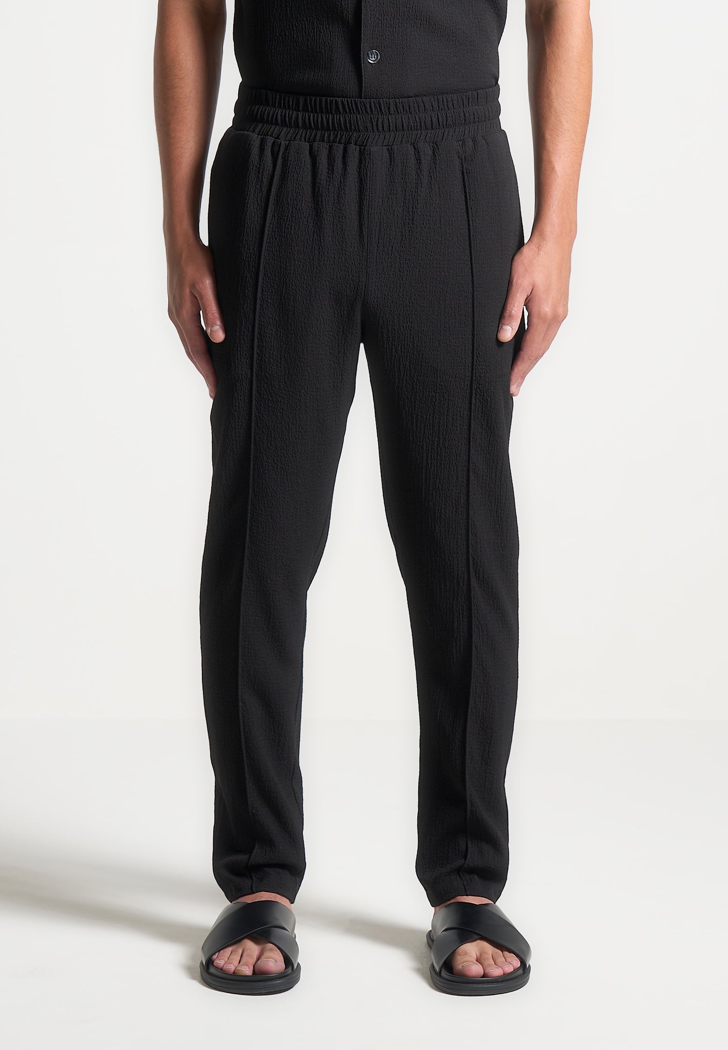 Black Seersucker Tapered Trousers with Elastic Waistband | Manière De Voir